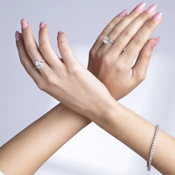 Rings on Hands by Forever Moissanite