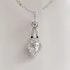 Pear-Cut Moissanite Pendant with Bezel-Set Accent and Halo